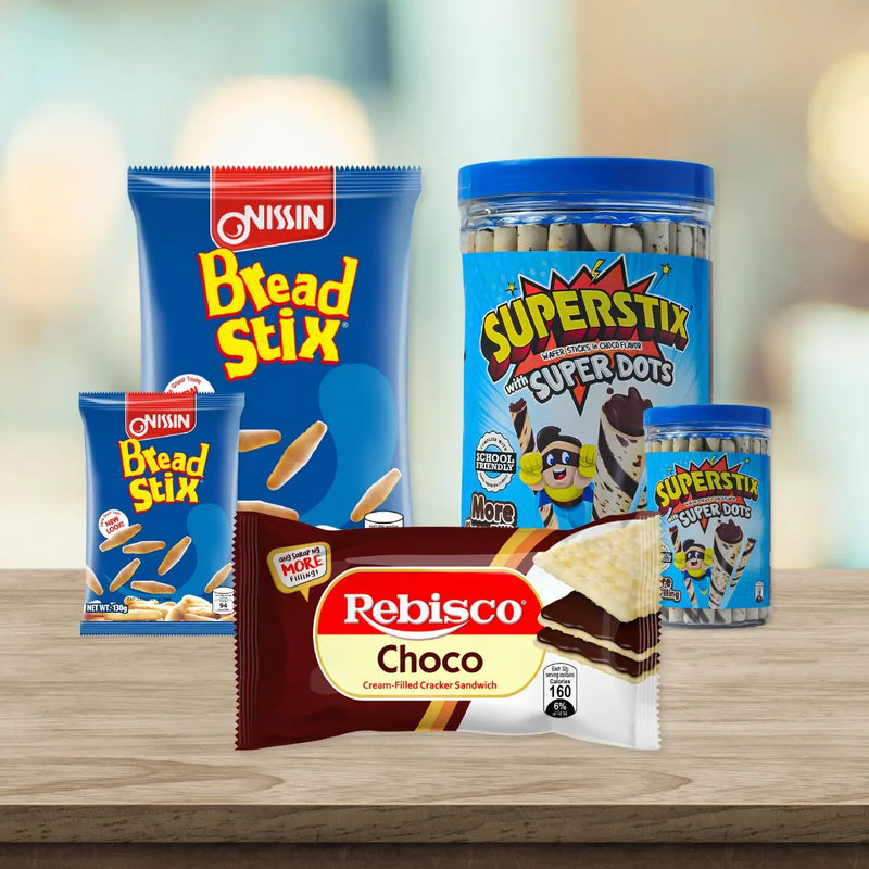 Popular biscuit and snack brands arranged on a wooden surface, featuring Nissin Bread Stix, Rebisco Choco crackers, and Super Stix wafer sticks.