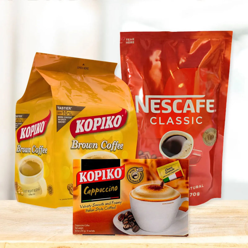 Coffee arrangement featuring a yellow Kopiko Brown bag, a red Nescafé Classic pouch, and a Kopiko Cappuccino box on wood.