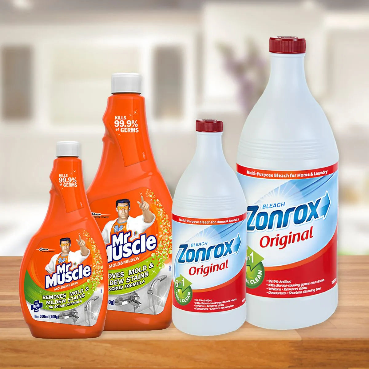 Household cleaning products arranged on a wooden surface, featuring Mr. Muscle Mold & Mildew spray bottles and Zonrox Original Bleach bottles.