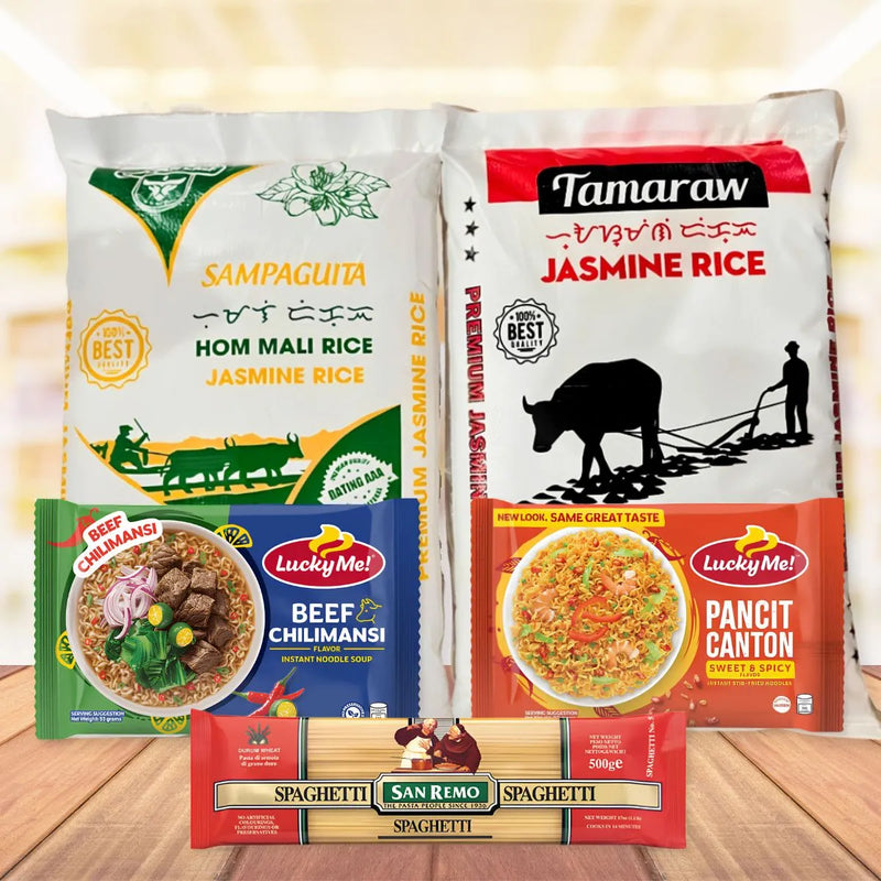 A collection of Filipino grocery items arranged on a wooden surface with a warm, glowing background. The products include a bag of Tamaraw Jasmine Rice, a bag of Sampaguita Hom Mali Jasmine Rice, Lucky Me! 