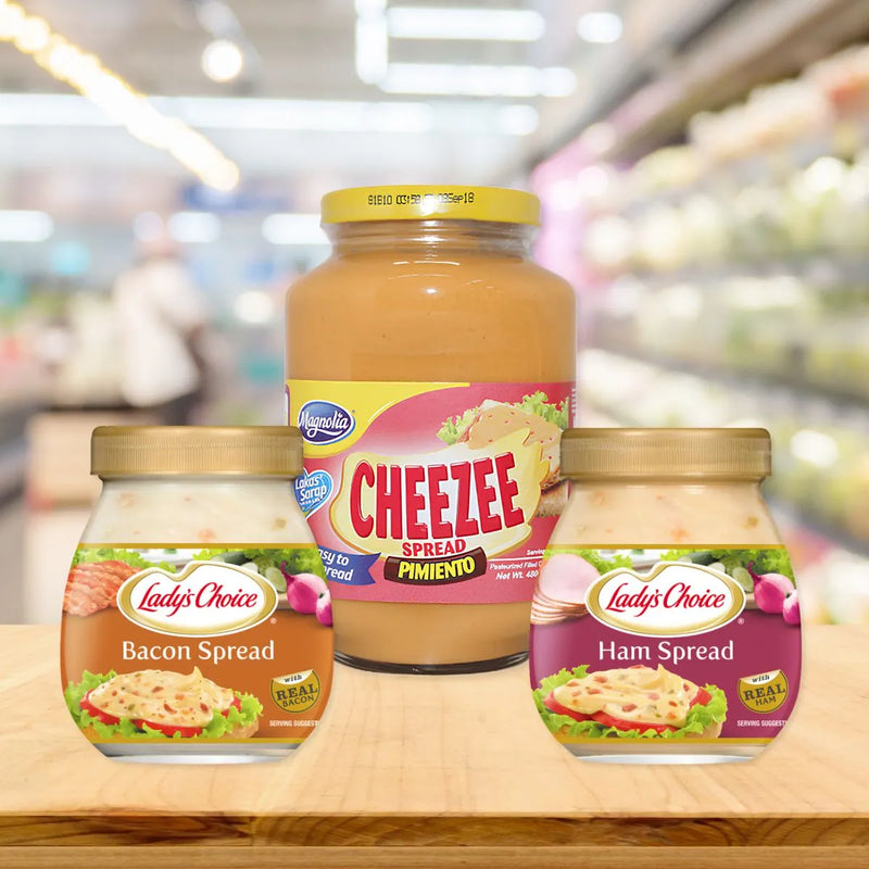 Three spread jars arranged on a wooden surface, featuring Magnolia Cheezee Pimiento, Lady’s Choice Bacon Spread, and Lady’s Choice Ham Spread.
