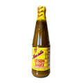 A bottle of Andok's Litson Sauce displayed against a black background, highlighting its yellow color and label design.