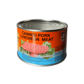 A can of pork luncheon meat displayed against a black background, showcasing its label and packaging design.
