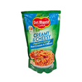 Close-up of cheesy pasta in a creamy sauce, highlighting its smooth consistency and appetizing appearance.