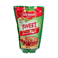 A packaging of Del Monte sweet and cheesy spaghetti, featuring vibrant red sauce and garnished with vegetables.