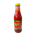 A bottle of hot chili sauce with a vibrant label, set against a solid black background.