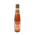 A bottle of sauce with a sleek design, prominently displayed against a black background.