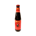 A bottle of red sauce with a label, set against a solid black background.