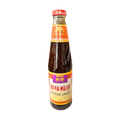 A bottle of oyster sauce displayed against a black background, highlighting its dark color and label design.