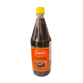 A dark bottle filled with brown liquid, set against a contrasting white backdrop.