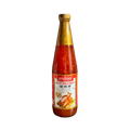 A bottle of hot sauce with a vibrant label, set against a solid black background.