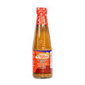 A bottle of hot sauce with a vibrant label, set against a solid black background.