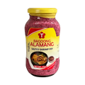 A glass jar filled with alamang, a traditional shrimp paste, set on a black backdrop.