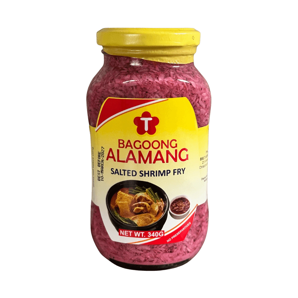 A glass jar filled with alamang, a traditional shrimp paste, set on a black backdrop.