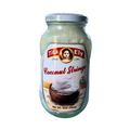 A jar of coconut strings placed on a white background, showcasing its creamy texture and label design.