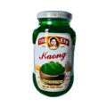 A sealed jar of green jelly, highlighting its bright hue and glossy surface.